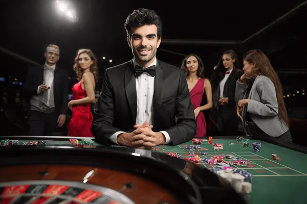 A glamorous woman holding casino chips in a neon-lit environment, representing the premium online casino atmosphere of KC666.