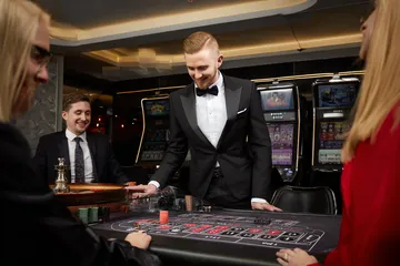 A stylish woman beside vibrant slot machines displaying glowing sevens, showcasing the variety of top slots at KC666.